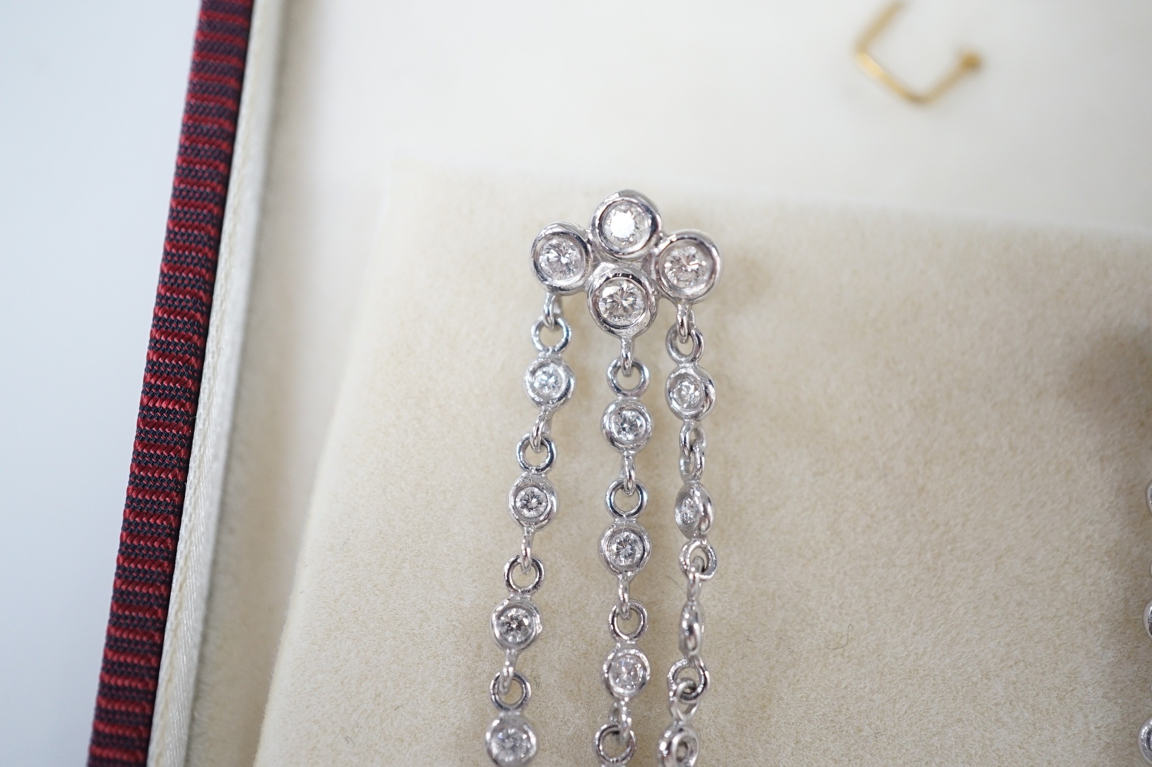 A modern pair of 750 white metal and diamond cluster set drop earrings, 42mm, gross weight 5.2 grams.